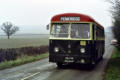 Green Bus Co 521 CTF passes, between trains